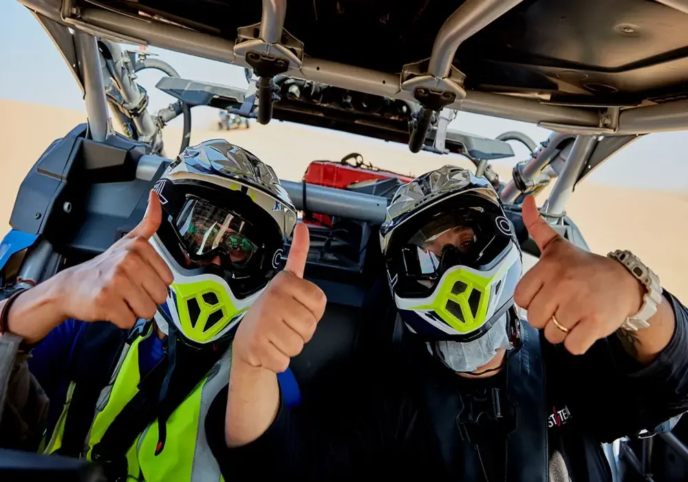 tourists riding dune buggies in DUbai